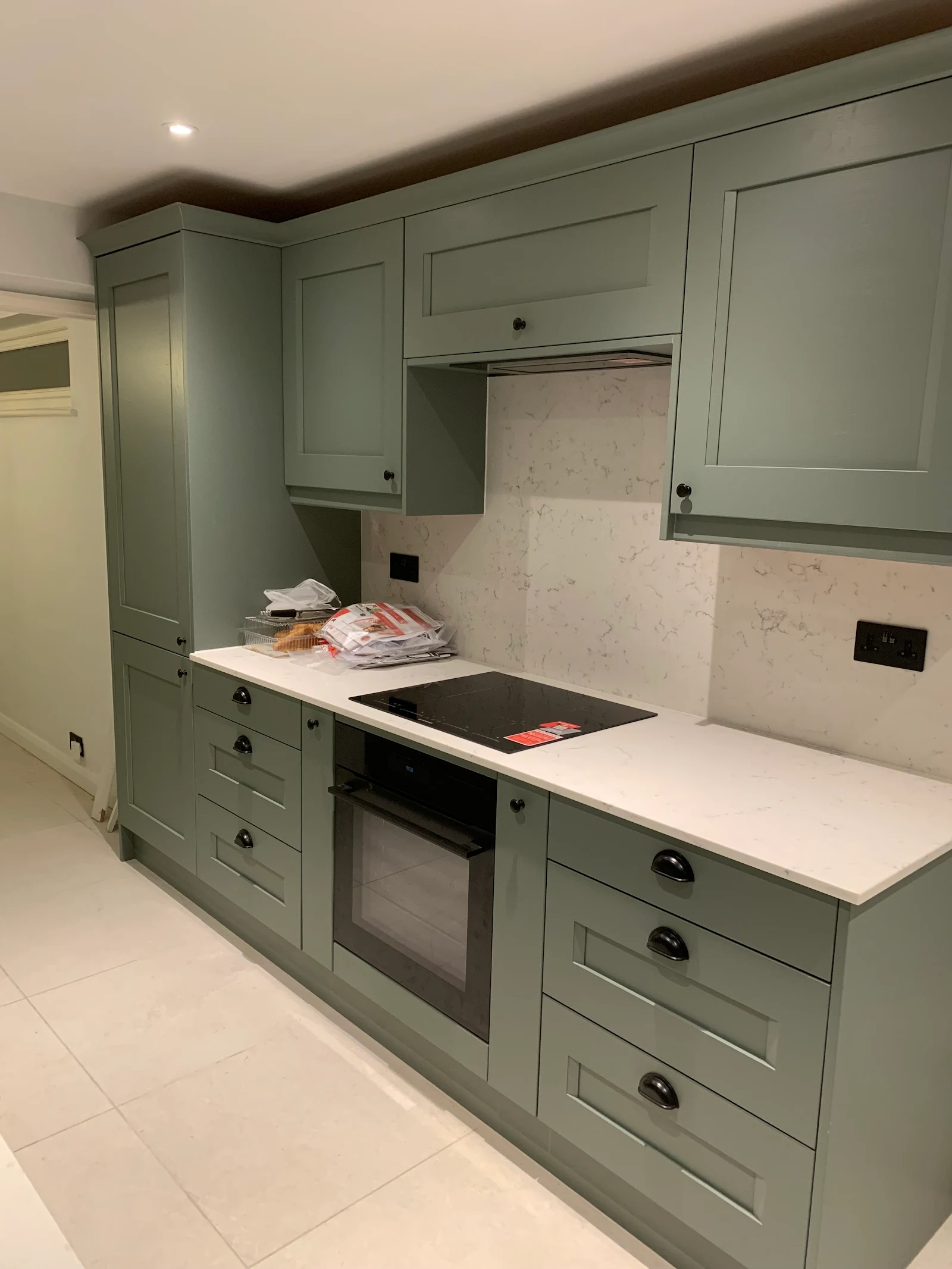 Sage green shaker kitchen with marble worktops