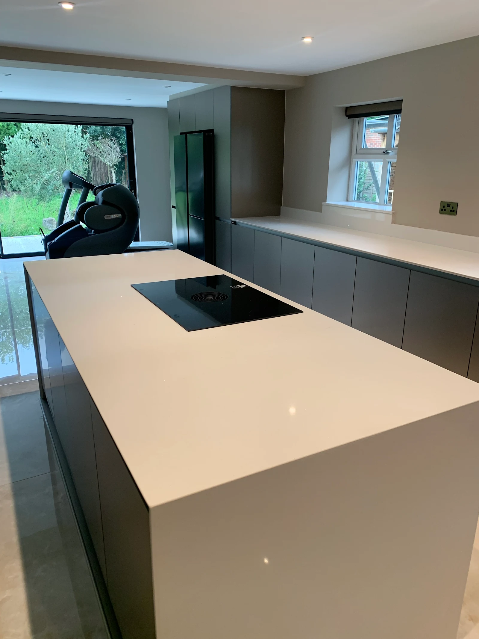 Minimal grey kitchen with white waterfall island